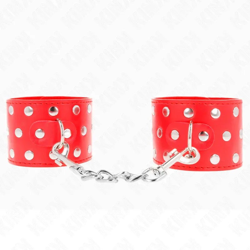 KINK - HANDGELENKFESSELN MIT DRUCKVERSCHLUSS VOLLER NIETEN ROT VERSTELLBAR 19-24 CM X 5,5 CM - Vanelion Paradise