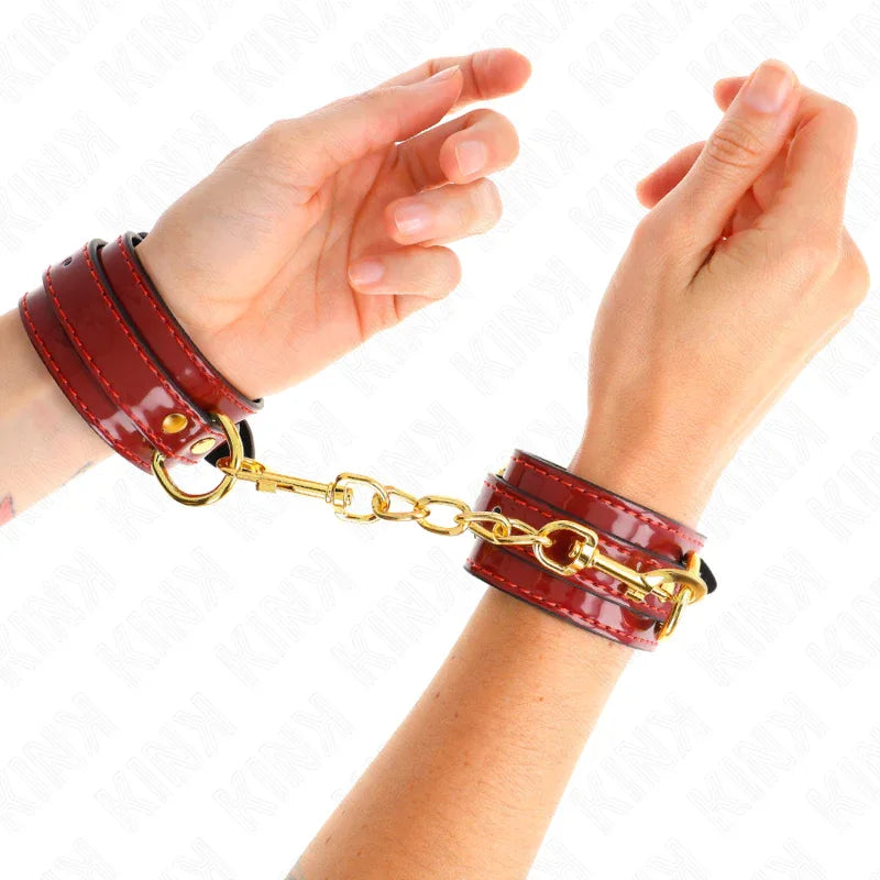 KINK - JOANNA ANGEL HANDGELENKMANSCHETTEN ROT VERSTELLBAR MIT GOLDKETTE 16,5-26 CM X 4 CM - Vanelion Paradise