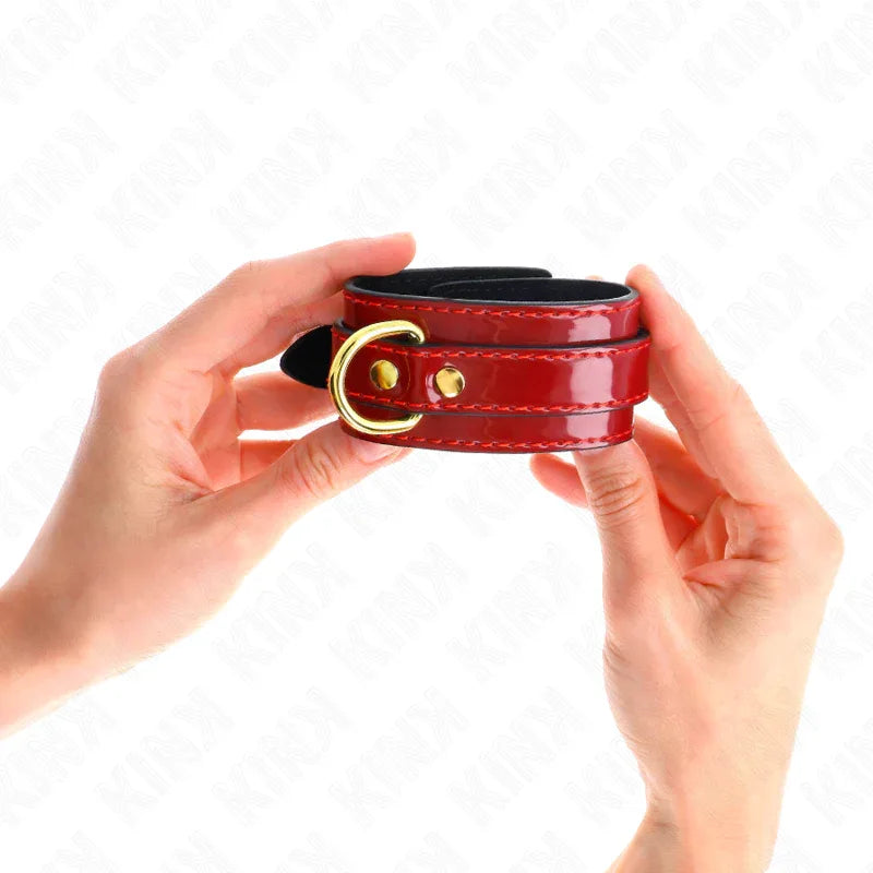 KINK - JOANNA ANGEL HANDGELENKMANSCHETTEN ROT VERSTELLBAR MIT GOLDKETTE 16,5-26 CM X 4 CM - Vanelion Paradise