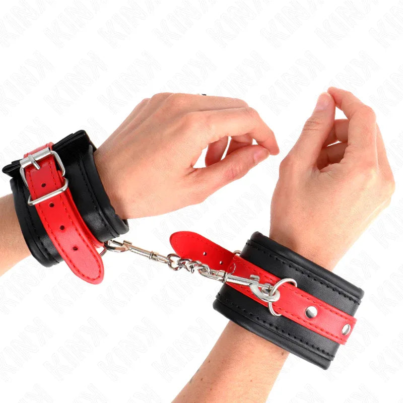 KINK - HANDGELENKFESSELN SCHWARZ MIT ROTEM GÜRTEL VERSTELLBAR 17-28 CM X 6 CM - Vanelion Paradise