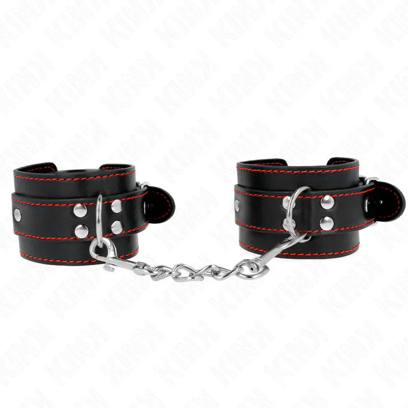 KINK - HANDGELENKFESSELN SCHWARZ MIT ROTEM FUTTER VERSTELLBAR 20-28 CM X 5,5 CM - Vanelion Paradise