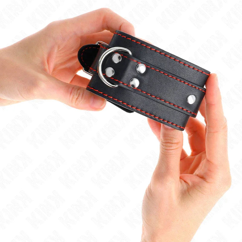 KINK - HANDGELENKFESSELN SCHWARZ MIT ROTEM FUTTER VERSTELLBAR 20-28 CM X 5,5 CM - Vanelion Paradise
